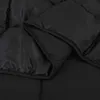 A close-up view of a black comforter, showing its quilted texture and folded edges. Anteprima dell’immagine prodotto