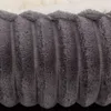 A close-up view of a textured gray fabric with a fluffy white lining visible at the top. Produktbild-Vorschau