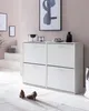A modern hallway with a white shoe cabinet, artwork on the wall, and a pair of shoes on the floor. Náhled obrázku produktu