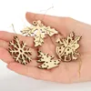 A hand holding several wooden Christmas ornaments. Produktbild-Vorschau