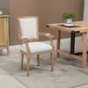A vintage-style armchair is placed next to a wooden dining table in a room. Produktbild-Vorschau