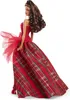 A Barbie doll wearing a red and plaid dress, shown from the side. Náhľad obrázku produktu