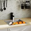 A kitchen sink with a faucet running water into it, filled with various fruits. Náhled obrázku produktu