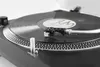 A close-up shot of a turntable with a vinyl record playing. Produktbild-Vorschau