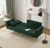 A green velvet sofa bed is shown in a living room setting with a fireplace and a floor lamp. Anteprima dell’immagine prodotto
