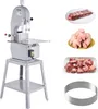 A commercial bone saw machine is shown alongside various cuts of meat and a set of saw blades. Produktbild-Vorschau