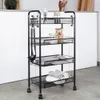 A black metal rolling cart with four shelves, filled with kitchen items and towels, placed on a gray floor in front of a white counter. Náhled obrázku produktu