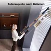 A woman is using a cordless vacuum cleaner to clean blinds in a modern interior. Produktbild-Vorschau