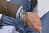 A person wearing a watch and jeans. Náhled obrázku produktu