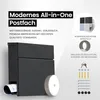 A dark gray modern mailbox with a newspaper rolled up in the slot and a circular LED light attached to the side. The background is white and light gray, with text and graphics describing the product's features and available colors. Anteprima dell’immagine prodotto
