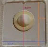 A close-up of a beige square product with a circular cutout, showing measurements indicated by colored lines and text. Anteprima dell’immagine prodotto