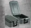 Two black fireproof document boxes are shown against a grey concrete background. One box is closed, and the other is open, revealing its interior. Produktbild-Vorschau