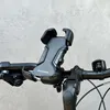 A close-up shot of a black Wozinsky phone holder mounted on a bicycle handlebar. Produktbild-Vorschau