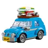 A blue LEGO Creator Volkswagen Beetle with a surfboard on top, set against a white background. Náhled obrázku produktu