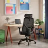A modern home office setup with a desk, chair, laptop, and artwork. Anteprima dell’immagine prodotto