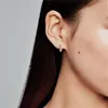 Close-up of a woman's ear wearing a small hoop earring. Produktbild-Vorschau