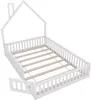 A white wooden house-shaped bed frame with a slatted base and a removable side panel, shown from a diagonal angle against a white background. Náhľad obrázku produktu
