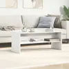 A white coffee table with books and a vase of water is placed in front of a sofa in a living room. Náhľad obrázku produktu