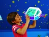 A young boy is playing with a toy spaceship, which has Buzz Lightyear inside. Produktbild-Vorschau