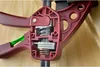 A close-up view of the internal mechanism of a red clamp. Náhled obrázku produktu