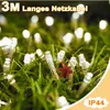 Close-up of white LED string lights nestled in green grass, with some lights out of focus in the background. Anteprima dell’immagine prodotto