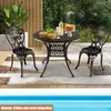A round table and two chairs set up on a patio next to a pool, with food and drinks on the table. Produktbild-Vorschau