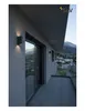 A modern balcony with a view of a town and mountains, featuring outdoor lighting. Produktbild-Vorschau