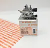 A Stihl carburetor is placed on its packaging box, with some protective wrapping in the foreground. Produktbild-Vorschau
