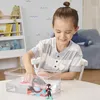A young boy is playing with a toy boat and action figures in a clear plastic tub of water. Anteprima dell’immagine prodotto