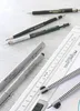 A collection of drawing and writing instruments, including pencils, pens, and a ruler, laid out on a light-colored surface. Produktbild-Vorschau