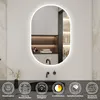A modern bathroom setting featuring an illuminated oval mirror above a sink. Produktbild-Vorschau