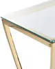 A close-up view of the corner of a console table with a gold metal frame and a glass top. Náhľad obrázku produktu