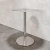 A standalone stainless steel bar table against a textured concrete wall. Produktbild-Vorschau