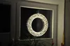 A decorative LED wreath hangs in a window, illuminated by its own lights. Produktbild-Vorschau