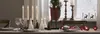 A festive table setting with candles and Christmas decorations. Produktbild-Vorschau