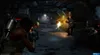 A group of soldiers in a dark, industrial-looking corridor are engaged in combat with alien creatures. Produktbild-Vorschau