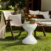 An outdoor patio scene with furniture and decorative items. Anteprima dell’immagine prodotto