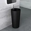 A black freestanding sink with a chrome faucet is shown in a modern bathroom with concrete walls and floor. Produktbild-Vorschau