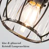 A close-up view of a black metal framed pendant light with clear crystal elements and a visible light bulb. Náhled obrázku produktu