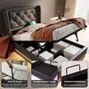 A bed with its storage compartment open, showing various features and storage solutions. Produktbild-Vorschau