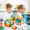 Two children are playing with magnetic building blocks on a table. Produktbild-Vorschau
