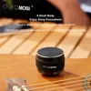 A small black speaker sits on a wooden surface, possibly a guitar, with text overlays describing its features. Podgląd zdjęcia produktu