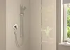 A shower head and control panel mounted on a tiled wall, with a glass shower enclosure and a window in the background. Náhľad obrázku produktu