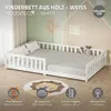 A white wooden children's bed with a slatted frame and guardrails, set up in a room with a decorative wall painting and a lion-themed rug. Produktbild-Vorschau