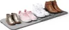 A collection of shoes arranged on a drying mat. Náhled obrázku produktu