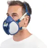 A man wearing a blue and white respirator mask. Produktbild-Vorschau