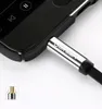 A close-up of a silver audio jack plugged into a smartphone. Anteprima dell’immagine prodotto