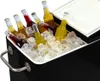 A black cooler filled with ice and several bottles of drinks. Produktbild-Vorschau