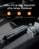 A black handheld vacuum cleaner is shown plugged into a car's center console. Produktbild-Vorschau