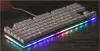 A white mechanical keyboard with RGB lighting on a wooden surface. Produktbild-Vorschau